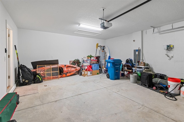 garage with water heater, concrete block wall, and a garage door opener