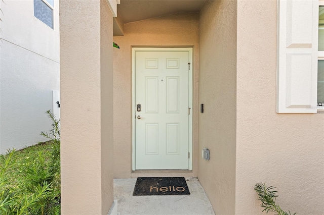 entrance to property with stucco siding