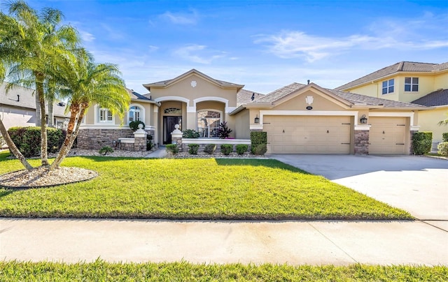 mediterranean / spanish house featuring stucco siding, concrete driveway, a garage, and a front yard