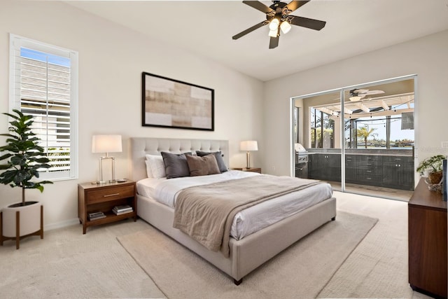 bedroom with access to exterior, multiple windows, light colored carpet, and vaulted ceiling