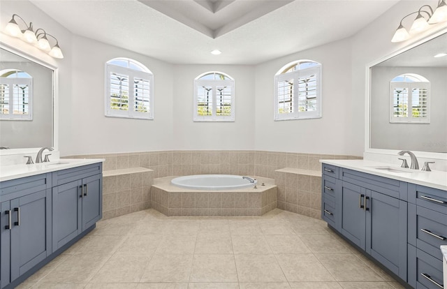 full bathroom featuring tile patterned floors, plenty of natural light, and a sink