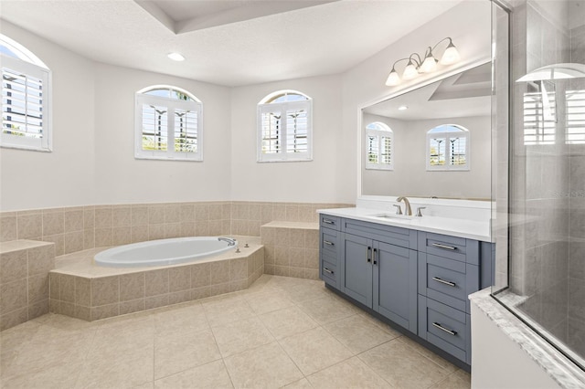 bathroom featuring tile patterned flooring, vanity, recessed lighting, a bath, and a textured ceiling