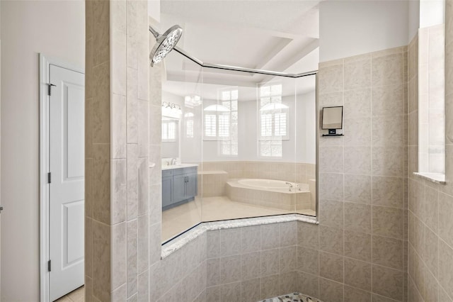 full bathroom with vanity, a bath, and a tile shower