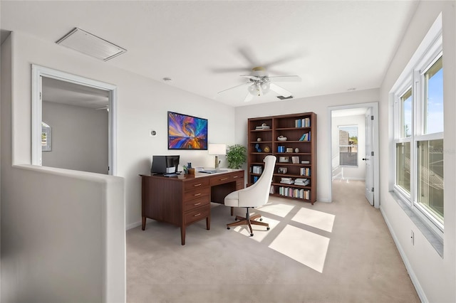 home office featuring visible vents, light colored carpet, baseboards, and ceiling fan