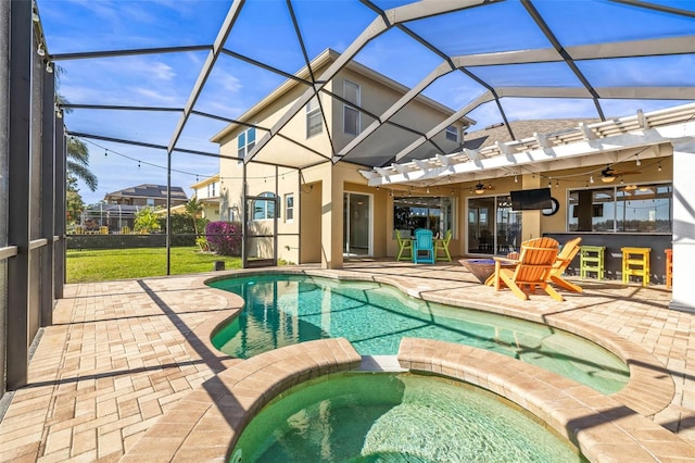 view of pool featuring a patio, a pool with connected hot tub, ceiling fan, a lanai, and outdoor dry bar