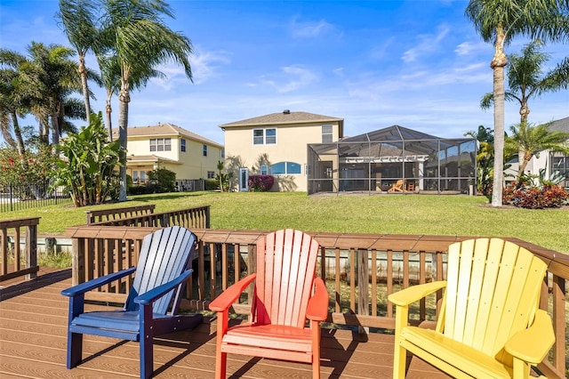 deck featuring glass enclosure, a yard, and a residential view