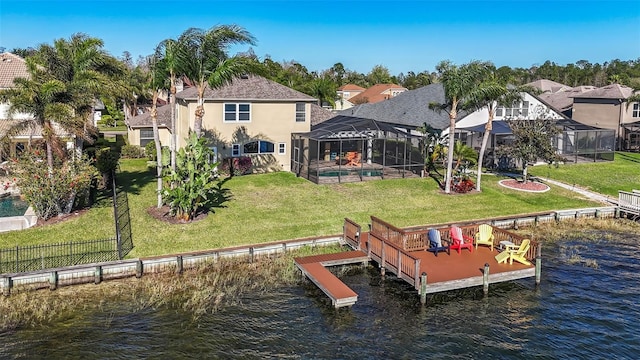 dock area with a residential view, glass enclosure, a lawn, and a water view