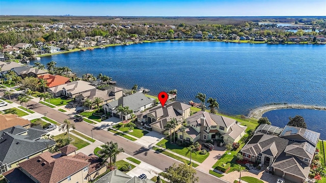 drone / aerial view featuring a residential view and a water view