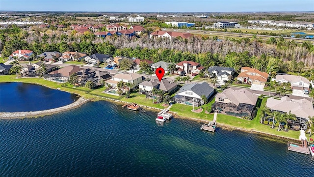 drone / aerial view featuring a residential view and a water view