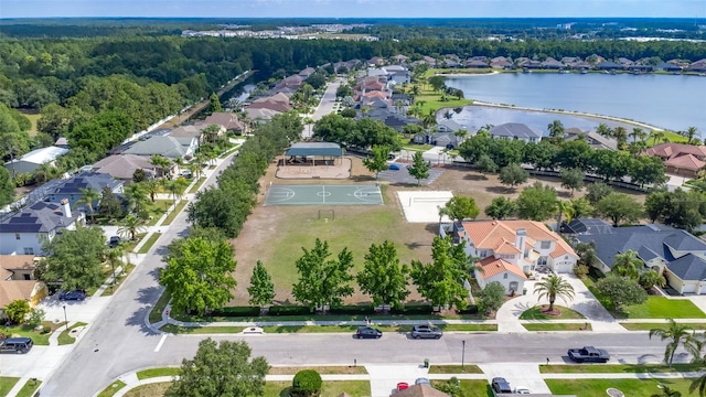 aerial view with a wooded view, a water view, and a residential view