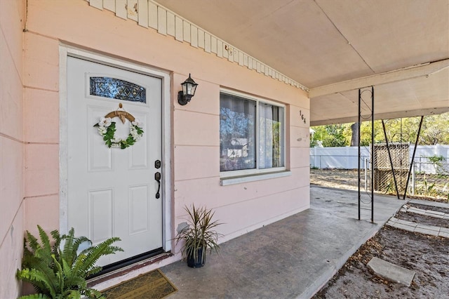 doorway to property with fence