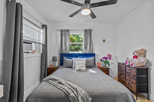 bedroom with ceiling fan, cooling unit, crown molding, and baseboards