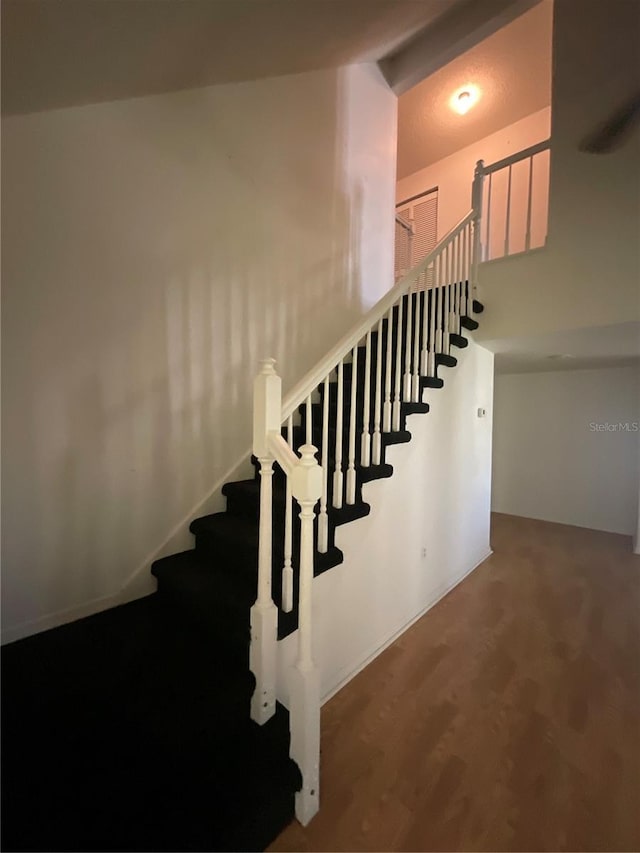 stairs with wood finished floors