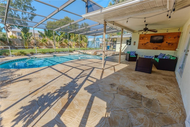 view of pool featuring glass enclosure, a patio, and a fenced backyard