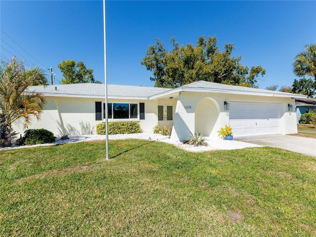 single story home with stucco siding, driveway, a front yard, and a garage