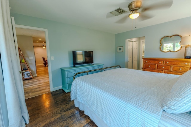 bedroom featuring visible vents, ceiling fan, baseboards, a closet, and dark wood-style floors