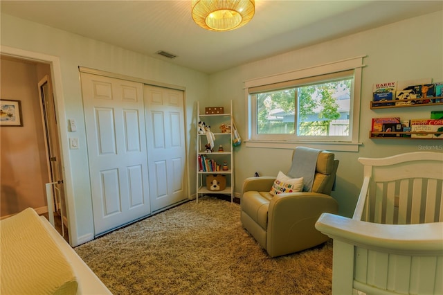 bedroom featuring a closet, visible vents, baseboards, and carpet floors