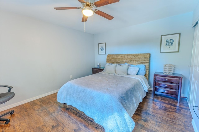 bedroom featuring a ceiling fan, wood finished floors, and baseboards