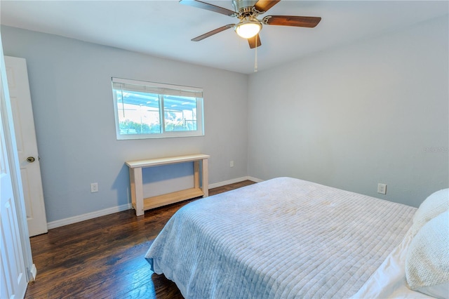 bedroom featuring ceiling fan, baseboards, and wood finished floors