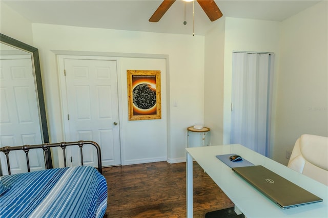 interior space featuring baseboards, ceiling fan, and dark wood-style flooring