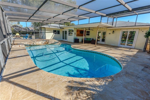 outdoor pool with ceiling fan, a lanai, french doors, an in ground hot tub, and a patio