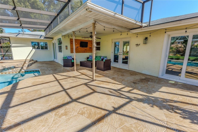 view of patio featuring ceiling fan, french doors, an outdoor pool, and a lanai