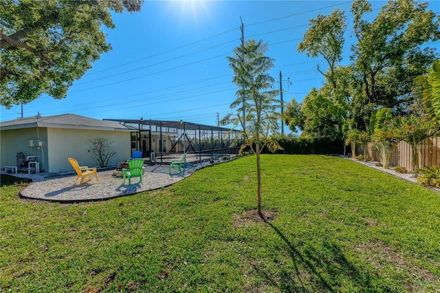 view of yard with a lanai, a patio, and a fenced backyard