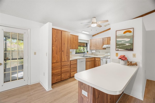 kitchen featuring white appliances, light wood-style floors, a peninsula, light countertops, and ceiling fan