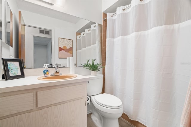 bathroom featuring visible vents, toilet, vanity, and a shower with curtain