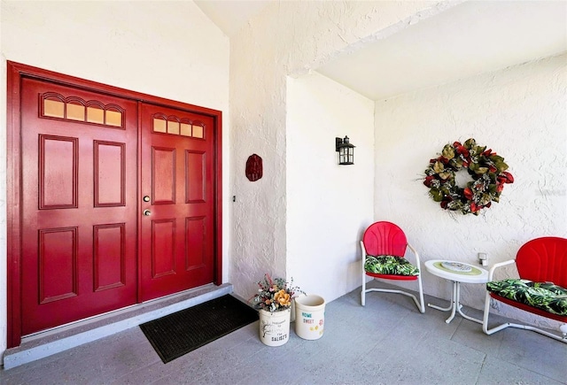 entrance to property with stucco siding