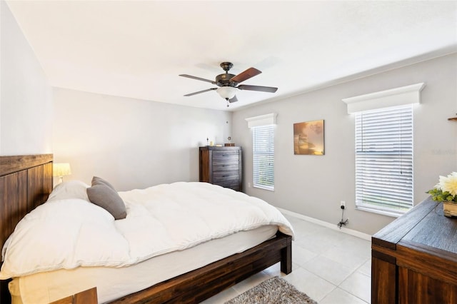 bedroom with light tile patterned floors, baseboards, and ceiling fan