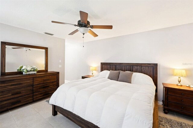 bedroom with light tile patterned floors, visible vents, and ceiling fan