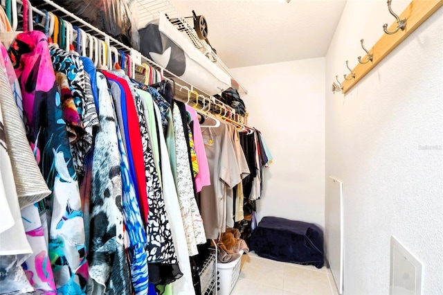 walk in closet with tile patterned flooring