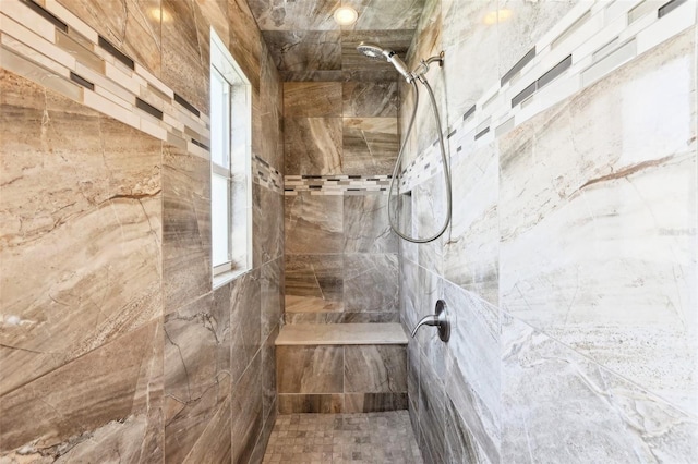 bathroom with a tile shower