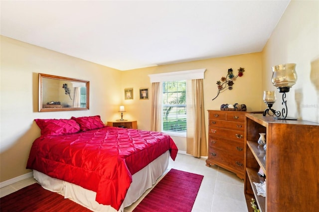 bedroom featuring light tile patterned flooring and baseboards