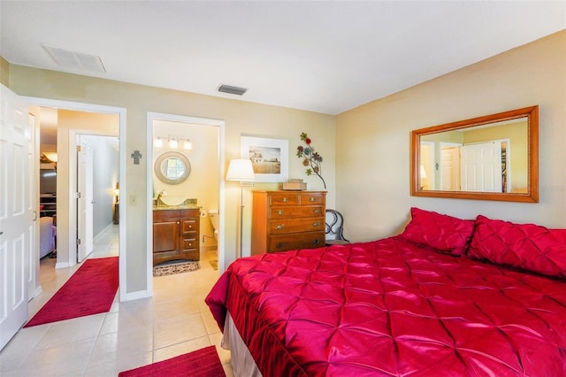 tiled bedroom featuring visible vents and connected bathroom