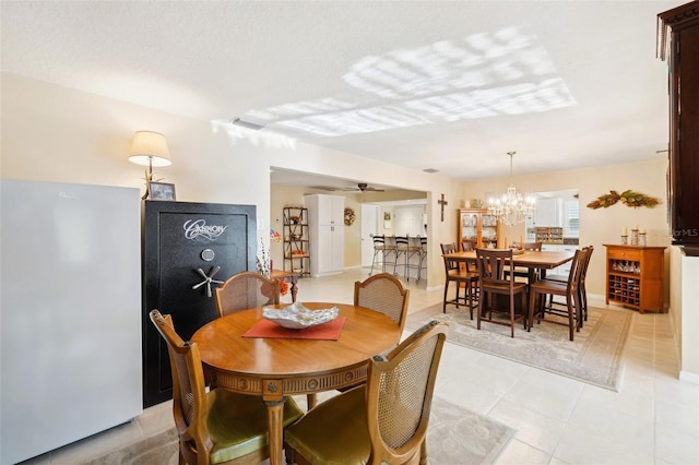 dining area with visible vents, ceiling fan with notable chandelier, and baseboards