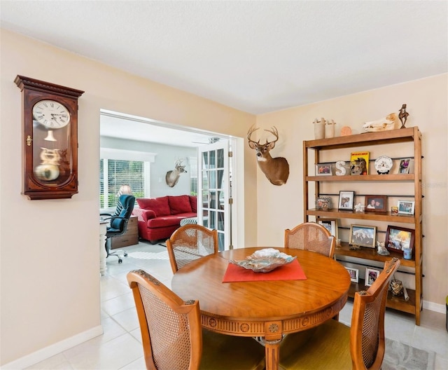 dining room featuring light tile patterned flooring and baseboards