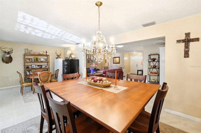 dining room with an inviting chandelier, light tile patterned flooring, baseboards, and visible vents