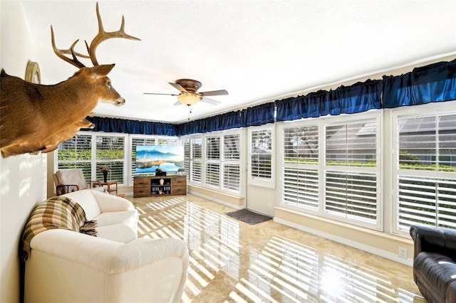 sunroom with a ceiling fan