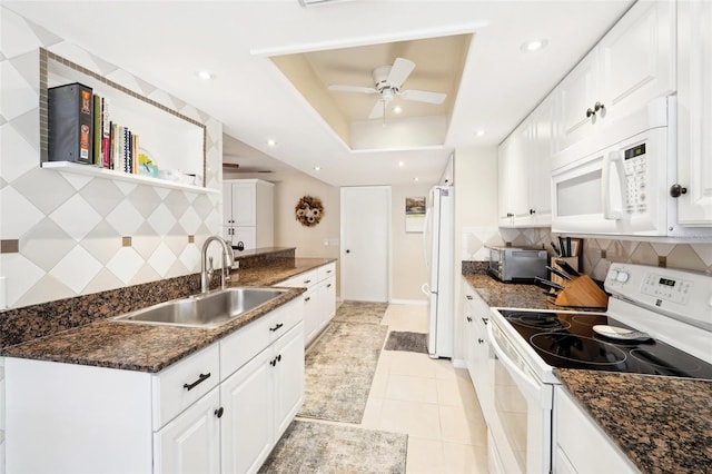 kitchen featuring ceiling fan, white cabinets, white appliances, a raised ceiling, and a sink