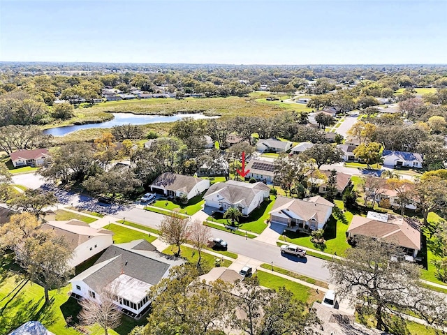 birds eye view of property with a residential view and a water view