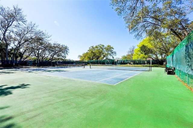 view of tennis court featuring fence