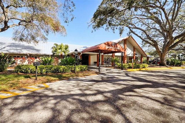 view of property's community featuring an attached carport and driveway