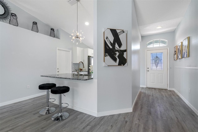 foyer featuring dark wood-type flooring and baseboards