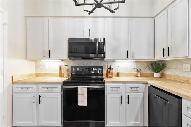 kitchen featuring electric range, butcher block countertops, decorative backsplash, white cabinetry, and stainless steel microwave