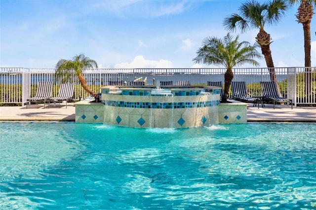 pool with a patio and fence