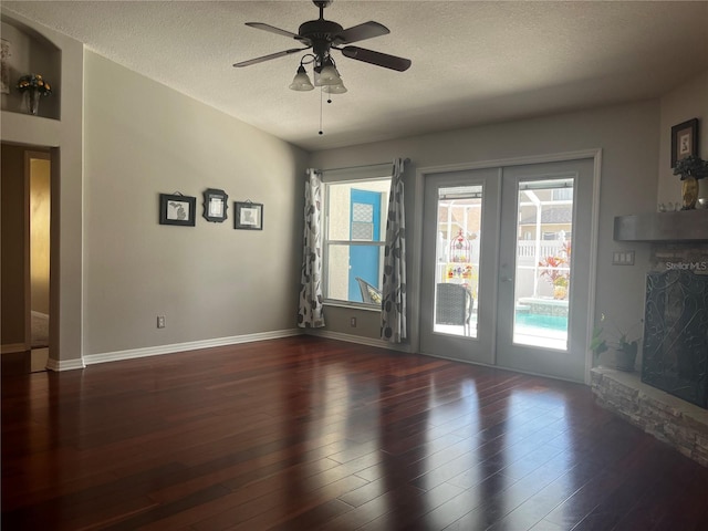 unfurnished living room with wood finished floors, french doors, and a healthy amount of sunlight