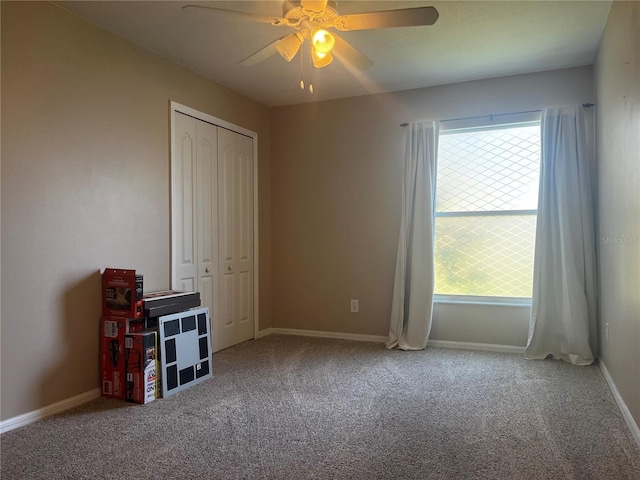 unfurnished bedroom with a closet, multiple windows, baseboards, and carpet