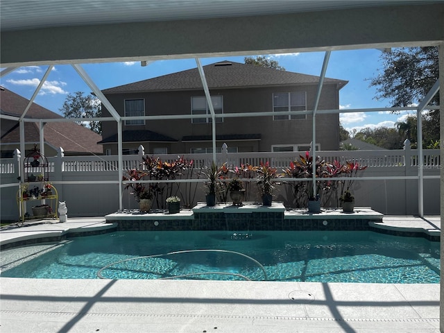 view of pool featuring a fenced in pool, glass enclosure, and a patio area